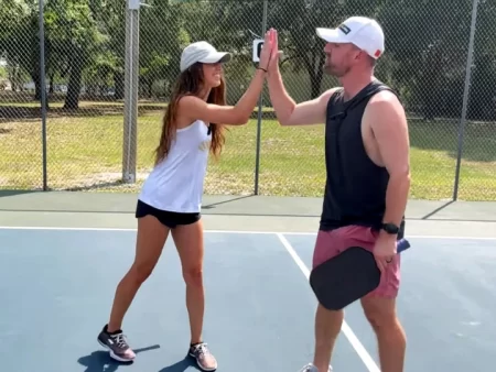 Couple playing pickleball, bonding on the court.