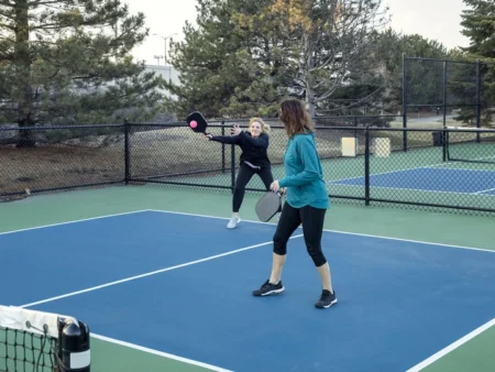 Pickleball players adjusting their techniques and strategies to conquer the challenges of windy conditions on the court.